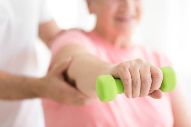 istock Elderly patient holding minor dumb-bell 859647388