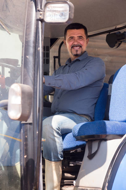 istock Farmer in large wheels tractor 859649702
