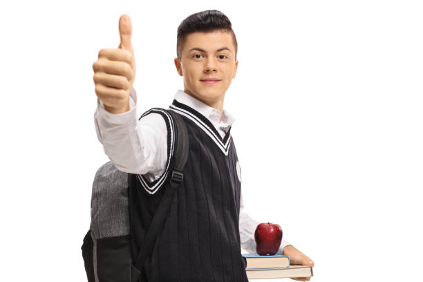 Teenage student making a thumb up gesture isolated on white background