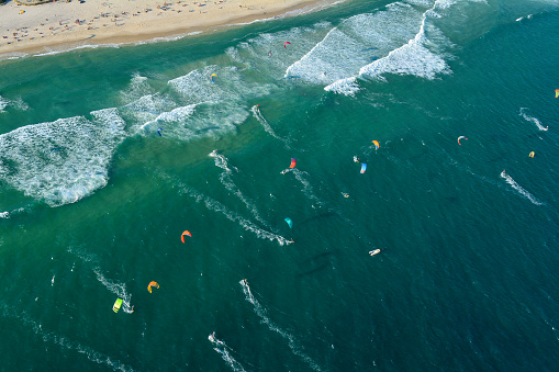 Aerial view of a beach full of kite surfers