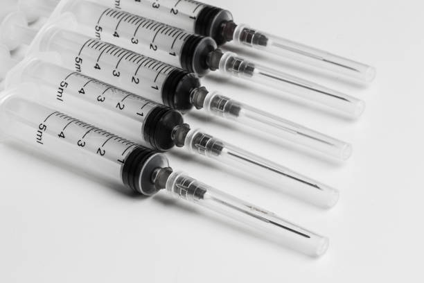 istock Disposable syringe in the row 859660050