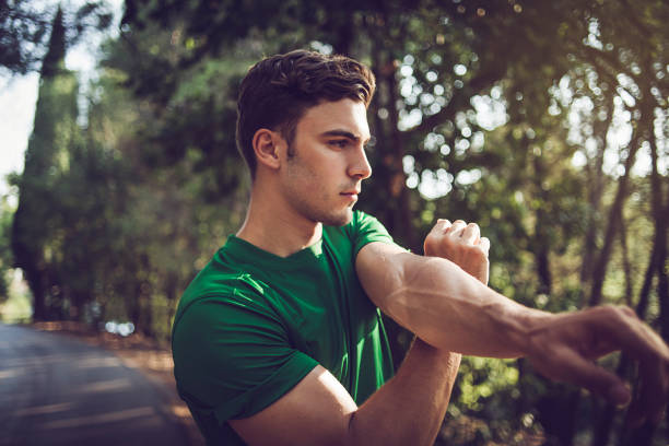 young man exercising in nature stock photo
