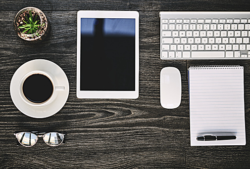 High angle shot of a variety of wireless devices on a work desk