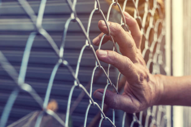 istock Hand is holding a steel cage 859665018