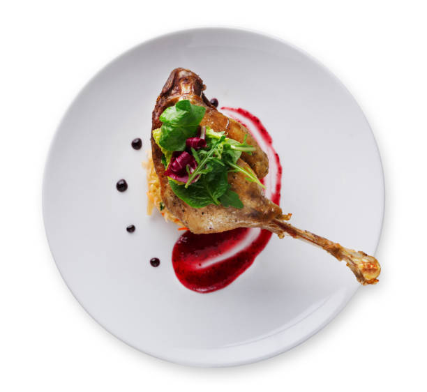 Duck confit with berry sauce isolated on white