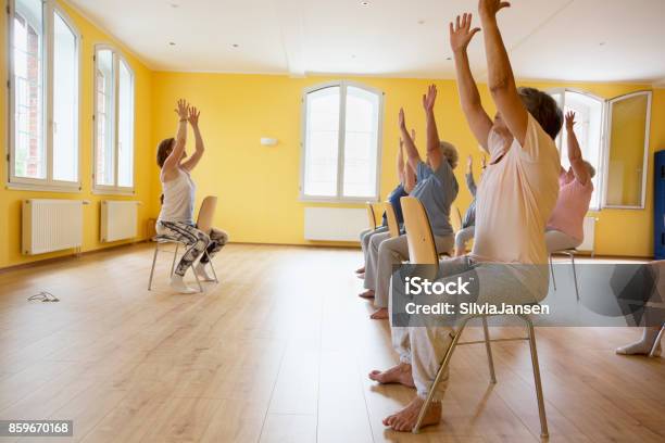 Teacher And Active Senior Women Yoga Class On Chairs Stock Photo - Download Image Now