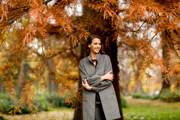 istock Young woman in the autumn forest 859670784
