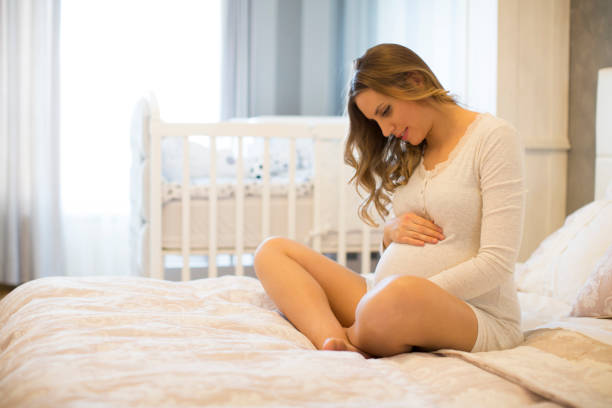 istock Pregnant woman on bed 859671738