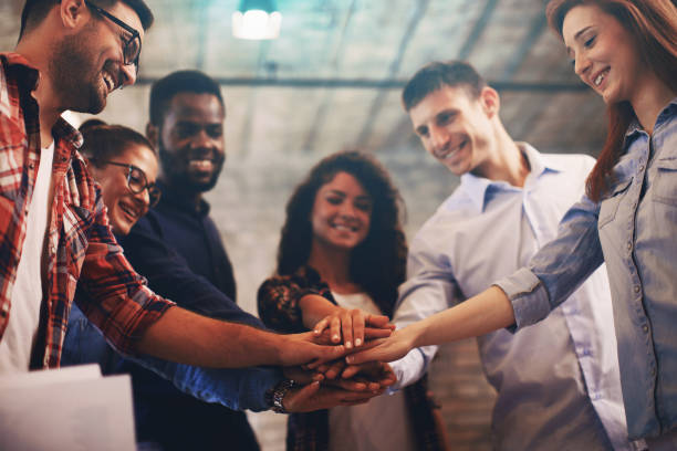 istock Young people showing team spirit focus on hands 859674390