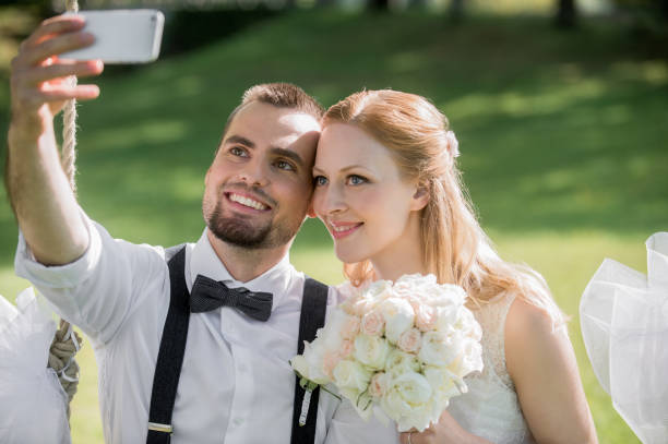 istock Bride and groom taking selfie photo 859674400