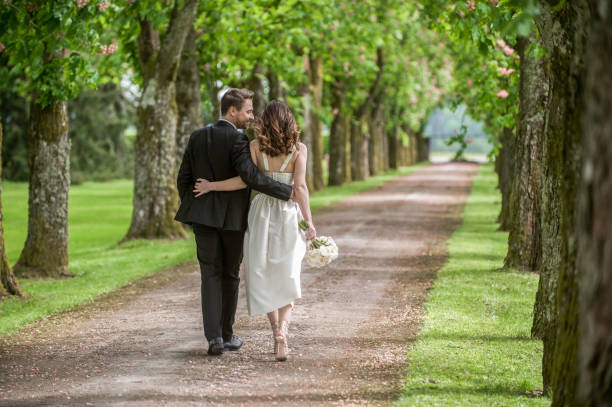 istock Bride and groom in park 859674448