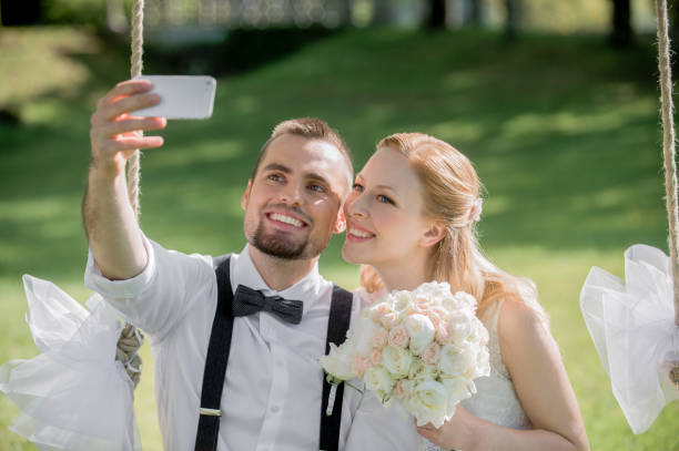 istock Bride and groom taking selfie photo 859674468