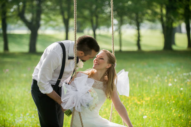 istock Bride and groom in park 859674568