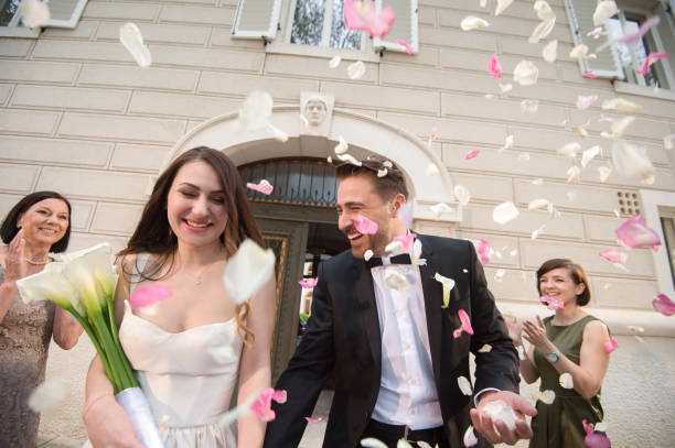 istock Friends throwing petals on wedding couple 859674578