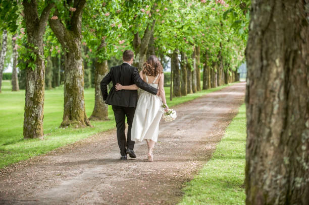 istock Bride and groom in park 859674586