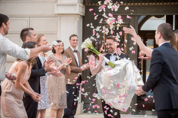 istock Friends throwing petals on wedding couple 859674604