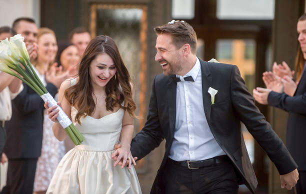 istock Bride and groom walking outside church 859674646