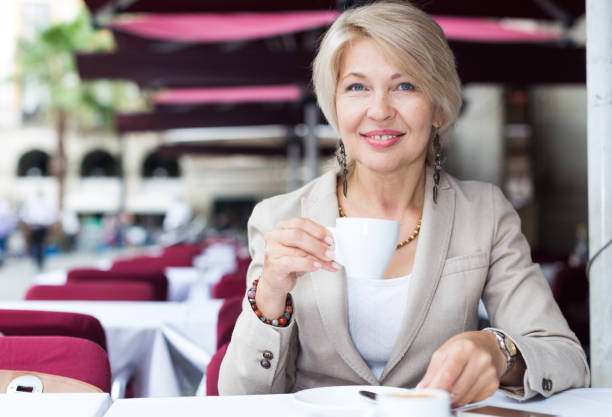 istock Mature woman 50s years old is lunching with coffee 859676876