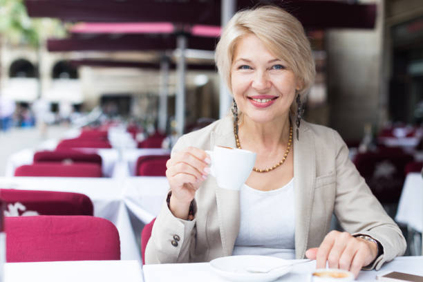 istock Mature woman 50s years old is lunching with coffee 859676892