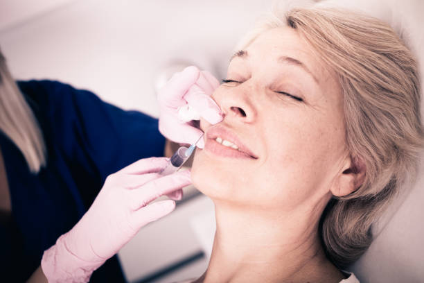istock Mature female receiving cosmetic injection 859677032