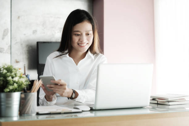 istock Young businesswoman using smart phone while working at her office desk background, business people and communication concept, office lifestyle 859680024