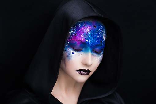 Creative make-up new conceptual idea. black blue bold body art painting. Crazy new graphic abstract picture on woman face surrealistic . professional photo. Creativity art lines conceptual planet sun