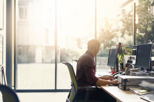 istock Businessman working on computer at desk in office 859684006