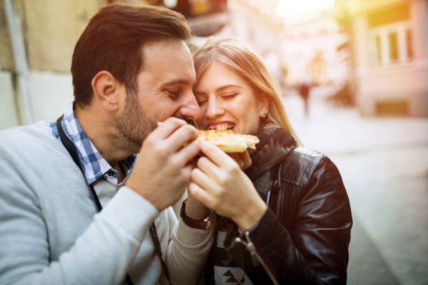 istock Tourist happy couple sharing pizza 859691586