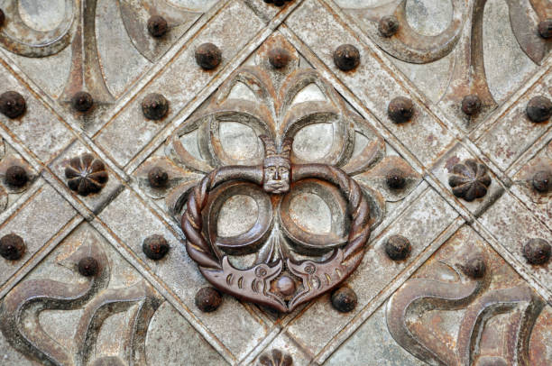istock Vintage metal door handle with stylized had and snakes. 859698820
