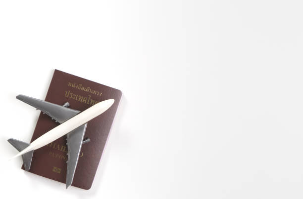 istock Toy plane on top of passport isolated on white copy space 859699414