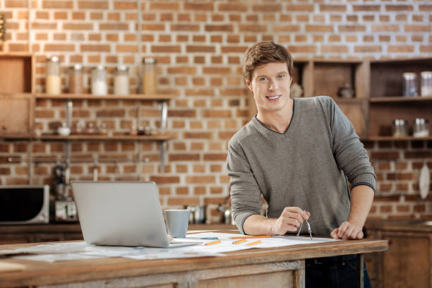 istock Pleasant young man holding a compass and smiling 859705038
