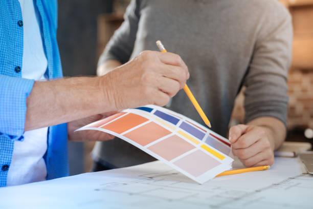 istock Male hands pointing at color chart with a pencil 859708248