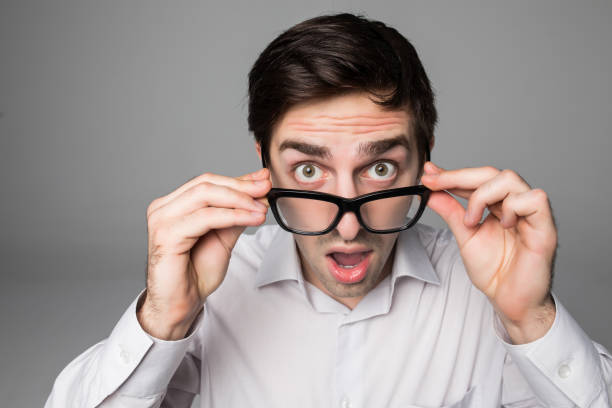 istock surprise entrepreneur holding his eyeglasses grey background studio 859710636