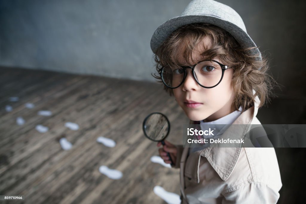 Little boy Little detective with a magnifying glass Detective Stock Photo