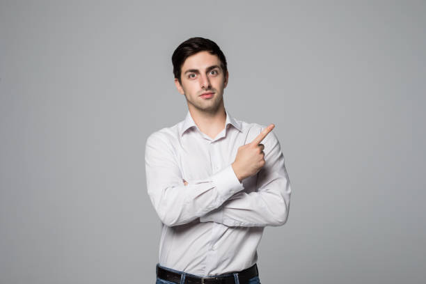 istock Handsome business man pointing space on gray background 859711092
