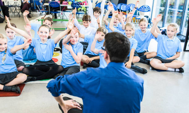 Education UK Primary School Assembly Children participating in morning assembly primary school assembly stock pictures, royalty-free photos & images