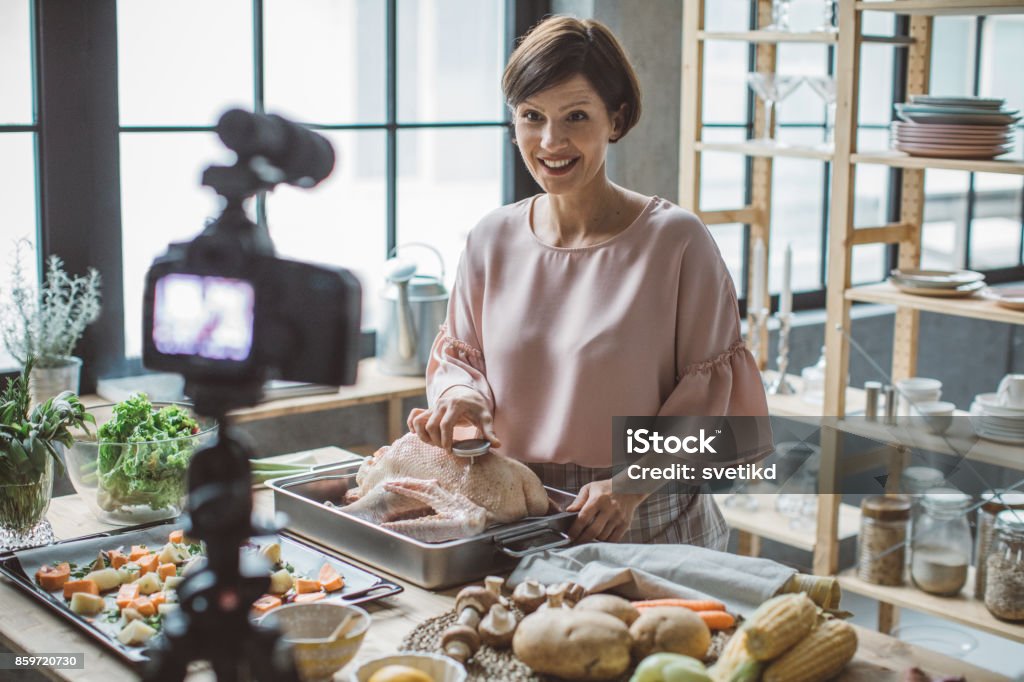 Thanksgiving recipes on my chanel Mid adult woman vlogging in her kitchen. 30-39 Years Stock Photo