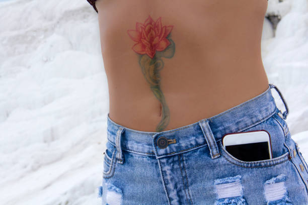 istock Rose tattooed female breast. 859723338