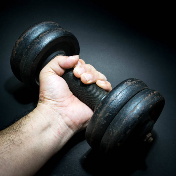 istock a man is holding a dumbbell 859723984