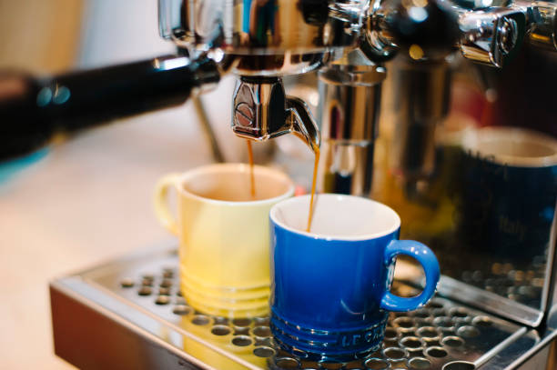 fresh morning espresso coffee with beautiful tiger crema pouring through the bottomless portafilter stock photo