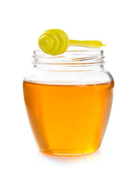 istock glass jar of honey on white background 859730434