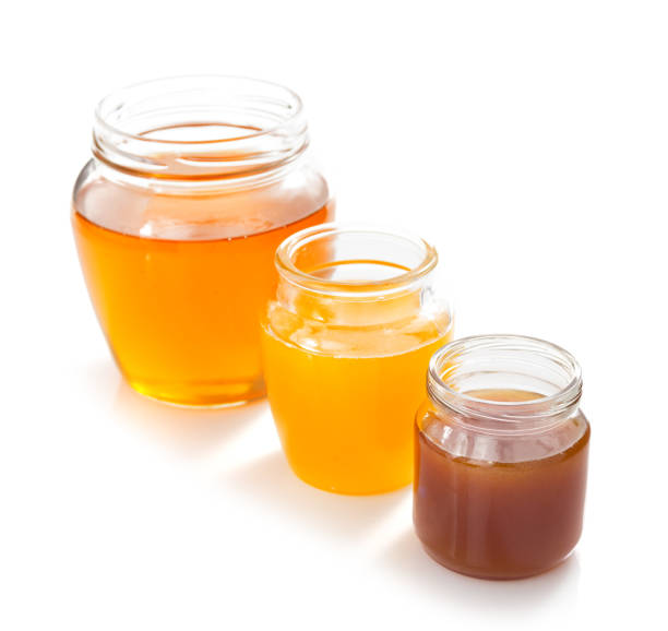 istock glass jar of honey on white background 859730506
