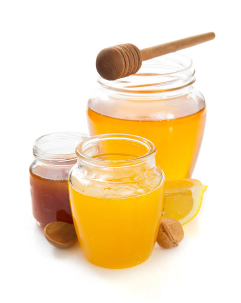 istock glass jar of honey on white background 859730562