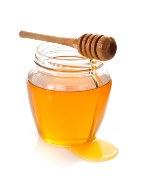 istock glass jar of honey on white background 859730594