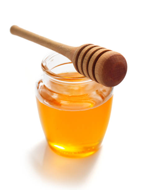 istock glass jar of honey on white background 859730938