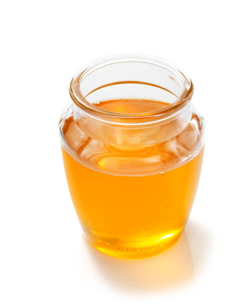 istock glass jar of honey on white background 859731116