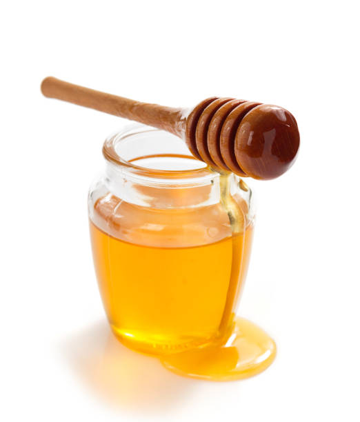 istock glass jar of honey on white background 859731380
