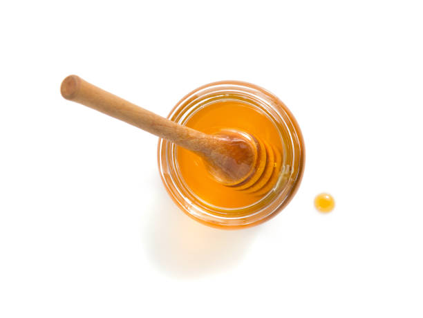 istock glass jar of honey on white background 859731402