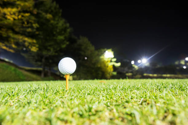 golf Golf ball on tee night golf stock pictures, royalty-free photos & images