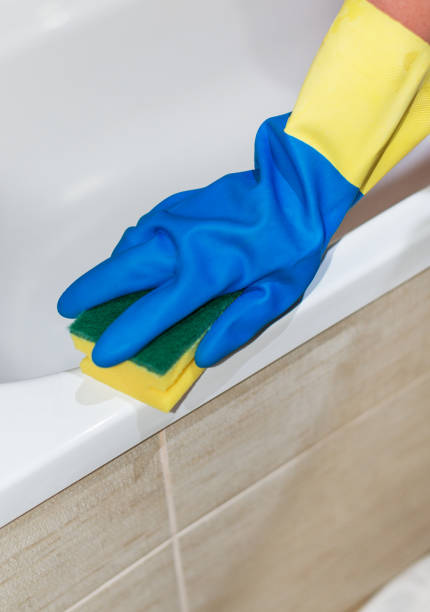 istock House cleaning. Woman cleaning a bath. 859735276